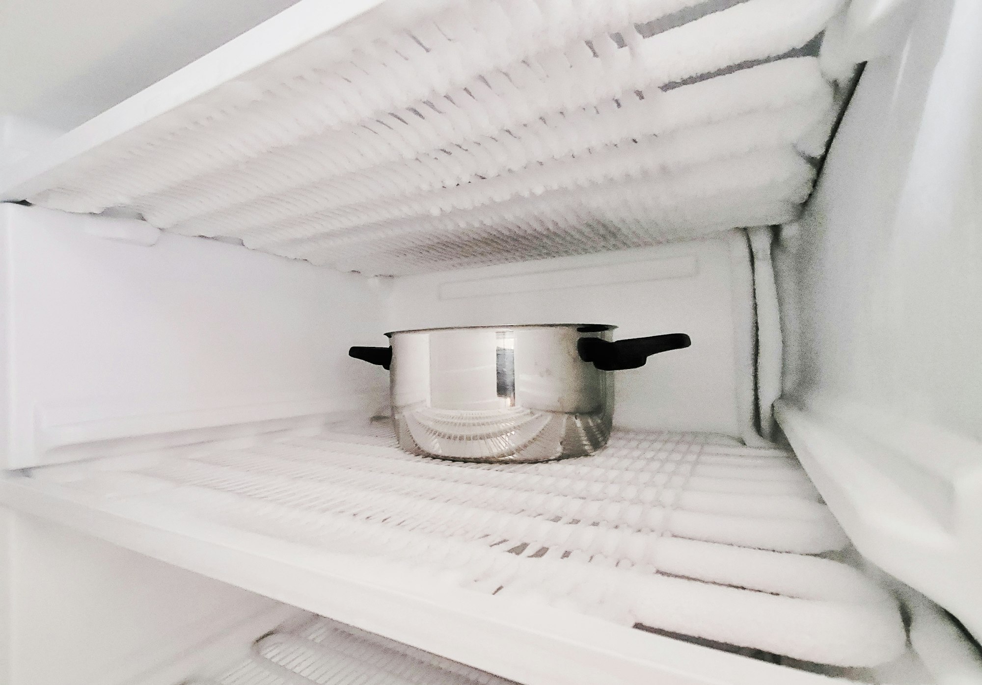 Defrost the freezer and refrigerator. Housekeeping, home keeping, house work, ice and frost, kitchen